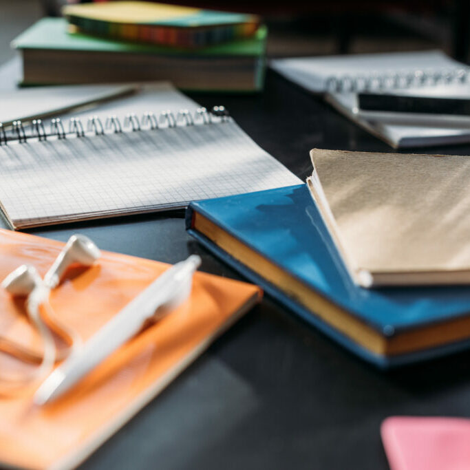 notebooks and books for studying on black table notebooks and books for studying on black table