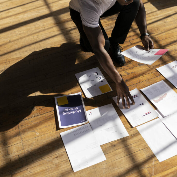 Working on the floor Businessman planning a marketing strategy